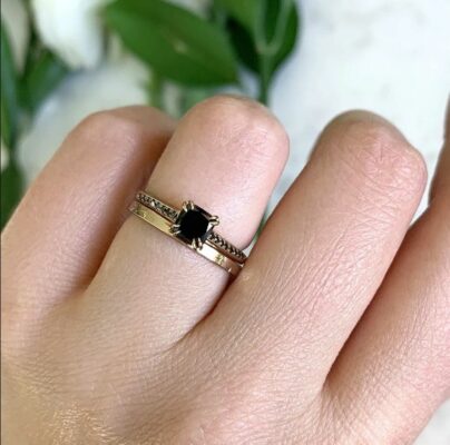 black diamond cushion cut ring on finger